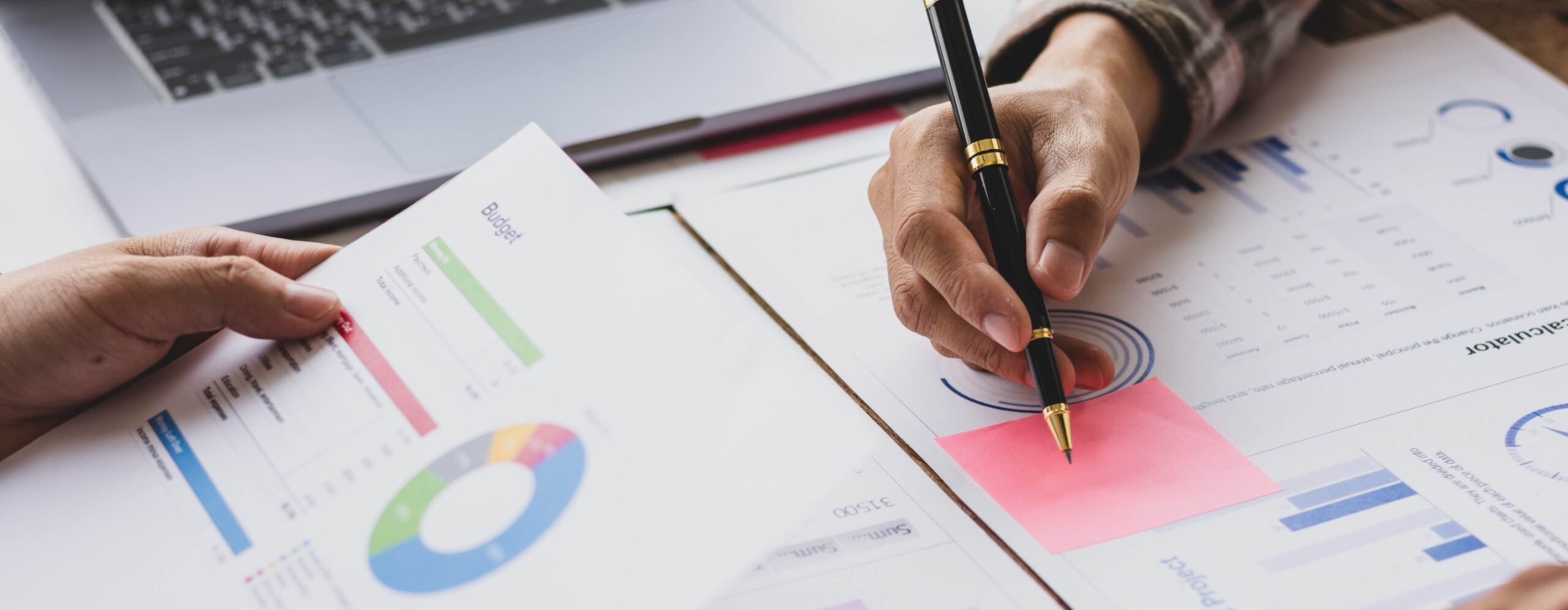 Businessman meeting with financial advisor, discussing analysis of financial charts in business report and planning company budget.