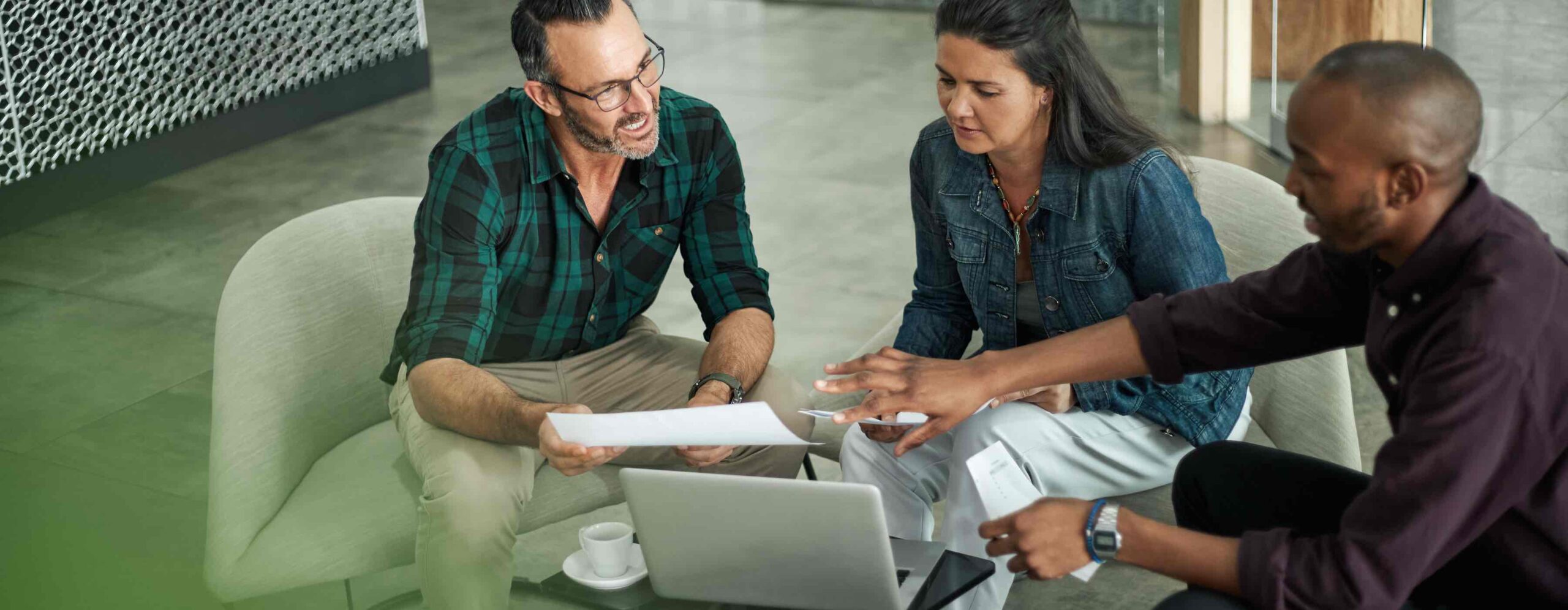 Casual meeting of diverse business team analyzing financial data